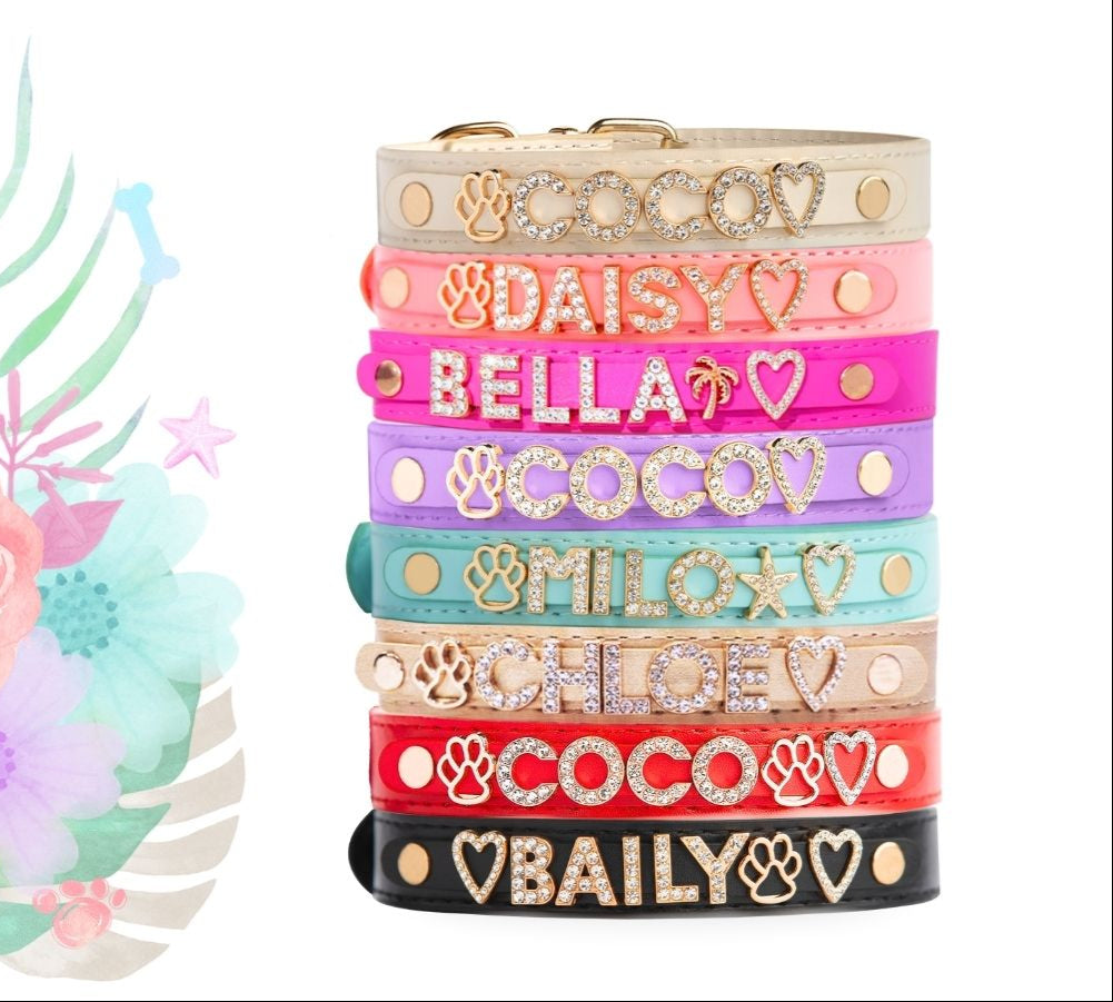 Stack of personalized luxury dog collars in pastel colors with gold-plated jewelry